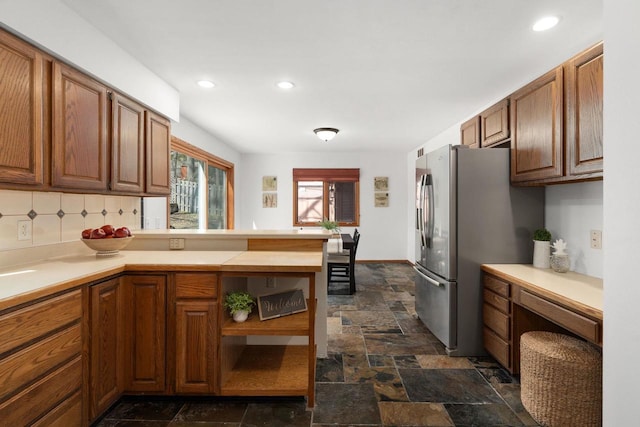 6208 Indian Mound Dr, Mcfarland, WI 53558 - kitchen featuring a peninsula, dark stone finish flooring, light countertops, recessed lighting, and brown cabinets