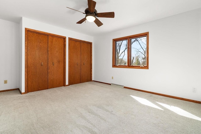 6208 Indian Mound Dr, Mcfarland, WI 53558 - unfurnished bedroom featuring multiple closets, light carpet, and baseboards