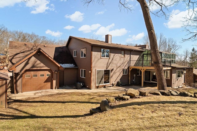 6208 Indian Mound Dr, Mcfarland, WI 53558 - back of house featuring cooling unit, a chimney, a deck, and a lawn