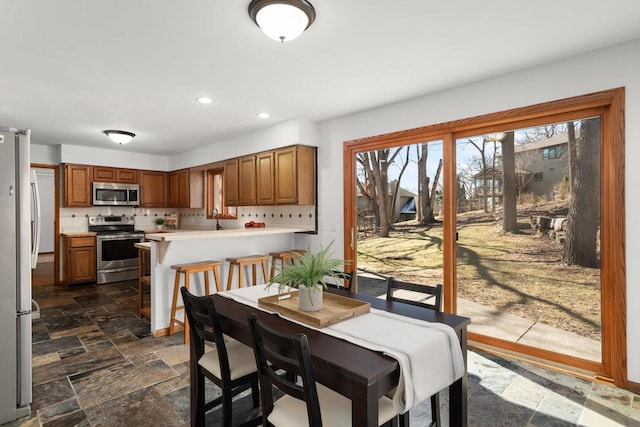 6208 Indian Mound Dr, Mcfarland, WI 53558 - dining area featuring stone tile flooring and recessed lighting