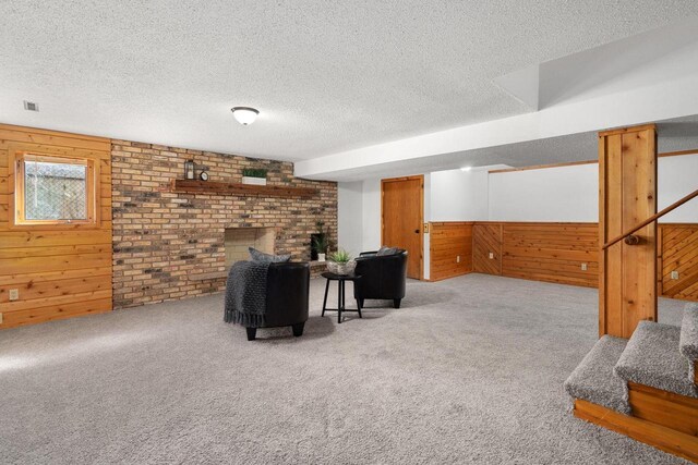 6208 Indian Mound Dr, Mcfarland, WI 53558 - living area with a textured ceiling, wooden walls, carpet floors, stairs, and a wainscoted wall
