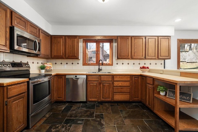 6208 Indian Mound Dr, Mcfarland, WI 53558 - kitchen featuring stainless steel appliances, a sink, backsplash, dark stone finish flooring, and recessed lighting