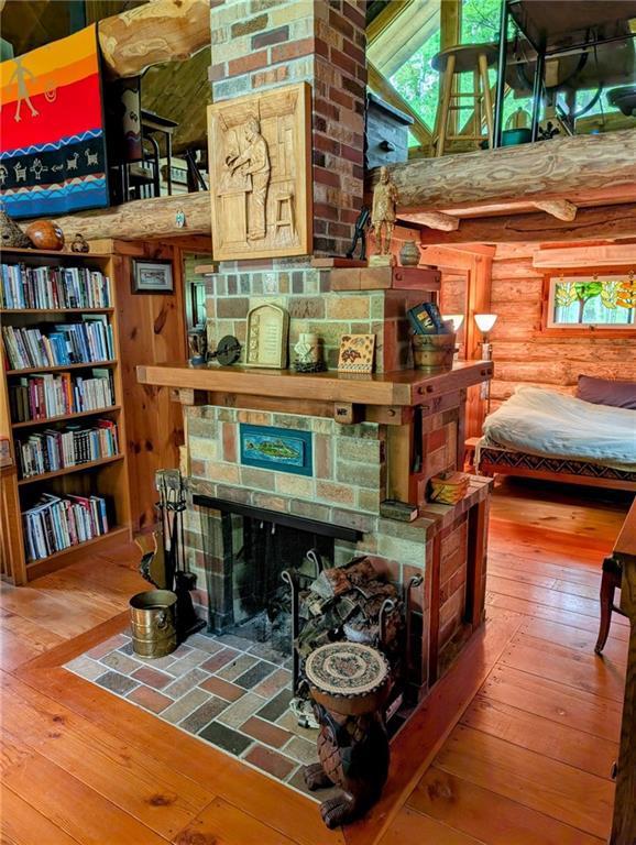 W16056 Camp Rd, Weyerhaeuser, WI 54895 - sitting room featuring rustic walls and wood-type flooring