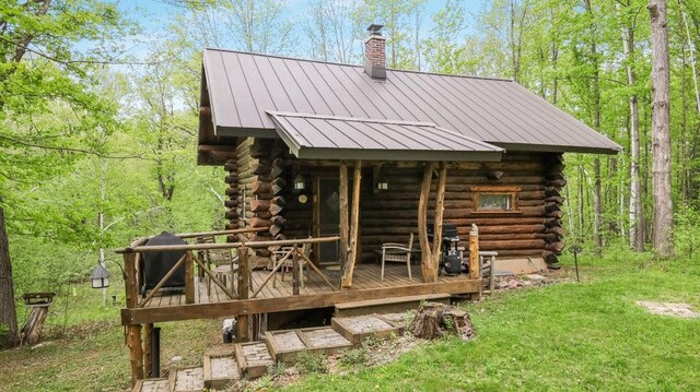 W16056 Camp Rd, Weyerhaeuser, WI 54895 - back of house featuring log siding, a standing seam roof, a chimney, and a deck