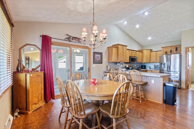 605 E Rime St, Orfordville, WI 53576 - dining space featuring wood finished floors, a chandelier, and high vaulted ceiling