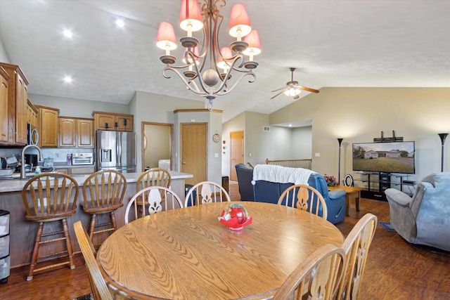 605 E Rime St, Orfordville, WI 53576 - dining area featuring dark wood-type flooring, vaulted ceiling, a ceiling fan, and a chandelier