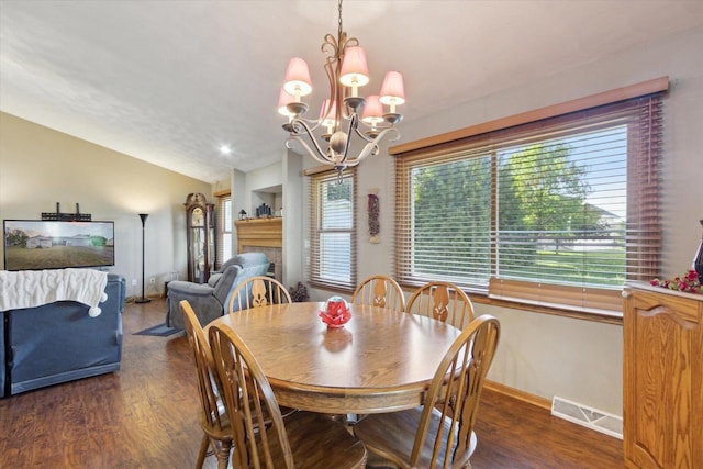 605 E Rime St, Orfordville, WI 53576 - dining space featuring wood finished floors, vaulted ceiling, baseboards, and a chandelier