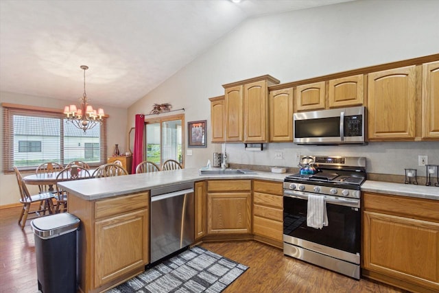 605 E Rime St, Orfordville, WI 53576 - kitchen with appliances with stainless steel finishes, vaulted ceiling, a peninsula, light countertops, and a chandelier