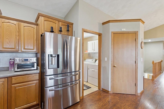 605 E Rime St, Orfordville, WI 53576 - kitchen with stainless steel fridge, washer and dryer, dark wood-style floors, light countertops, and brown cabinets