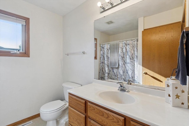 605 E Rime St, Orfordville, WI 53576 - bathroom featuring vanity, toilet, baseboards, and a shower with shower curtain
