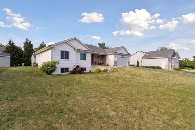 605 E Rime St, Orfordville, WI 53576 - ranch-style home with a garage, driveway, and a front lawn