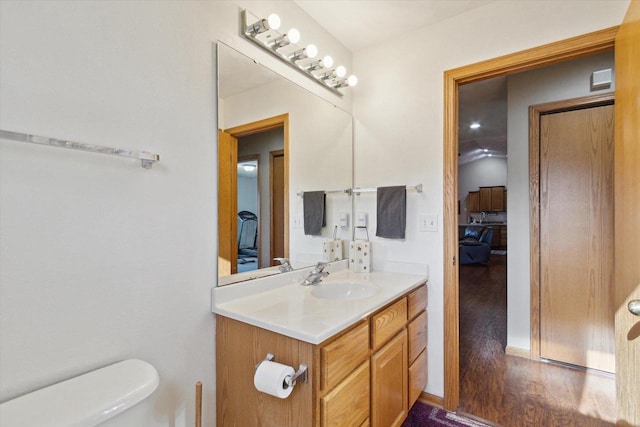 605 E Rime St, Orfordville, WI 53576 - half bath featuring toilet, vanity, and wood finished floors