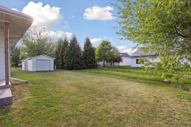 605 E Rime St, Orfordville, WI 53576 - view of grassy yard with an outdoor structure and a garage