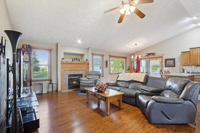 605 E Rime St, Orfordville, WI 53576 - living area featuring wood finished floors, healthy amount of natural light, lofted ceiling, ceiling fan, and a tiled fireplace