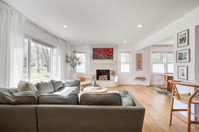 6935 N Yates Rd, Fox Point, WI 53217 - living room with light wood finished floors, a brick fireplace, and recessed lighting