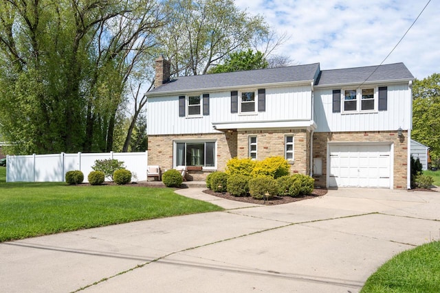 6935 N Yates Rd, Fox Point, WI 53217 - view of front of property with a chimney, concrete driveway, a garage, brick siding, and board and batten siding