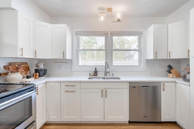 6935 N Yates Rd, Fox Point, WI 53217 - kitchen featuring appliances with stainless steel finishes, a sink, plenty of natural light, and white cabinets