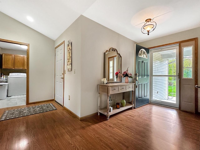 N2242 Keller Rd, Marinette, WI 54143 - entrance foyer featuring washer / clothes dryer, wood finished floors, vaulted ceiling, and baseboards