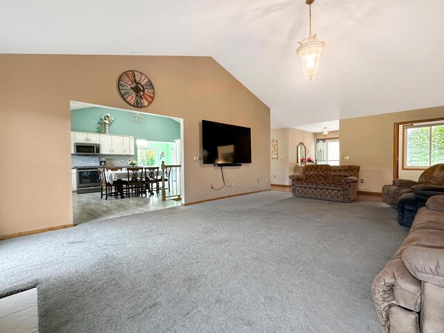 N2242 Keller Rd, Marinette, WI 54143 - living room featuring light colored carpet, high vaulted ceiling, and baseboards