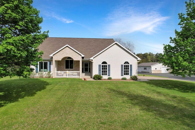N2242 Keller Rd, Marinette, WI 54143 - ranch-style house featuring a front lawn, covered porch, and a shingled roof