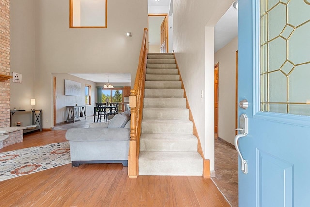 N3270 State Rd 76, Hortonville, WI 54944 - entryway featuring a high ceiling, stairs, wood finished floors, and a chandelier