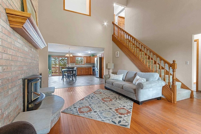 N3270 State Rd 76, Hortonville, WI 54944 - living room with light wood-style flooring, a high ceiling, stairs, and a chandelier