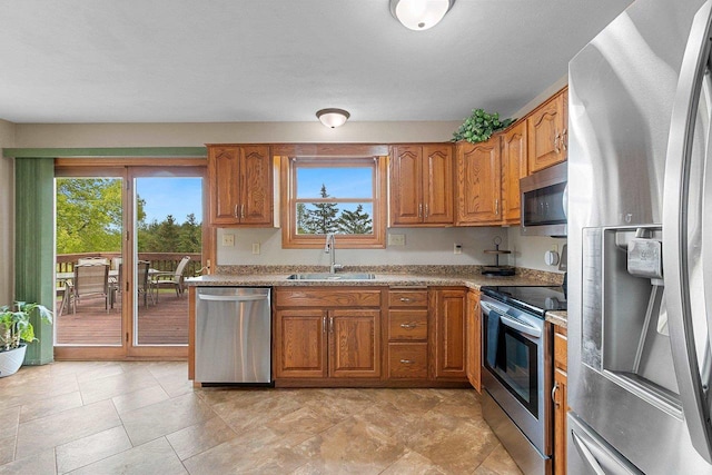 N3270 State Rd 76, Hortonville, WI 54944 - kitchen featuring appliances with stainless steel finishes, a sink, brown cabinetry, and light countertops