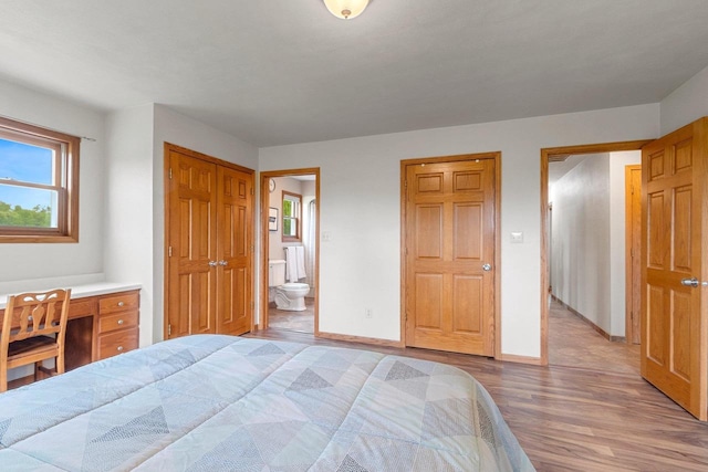 N3270 State Rd 76, Hortonville, WI 54944 - bedroom featuring light wood finished floors, baseboards, and connected bathroom