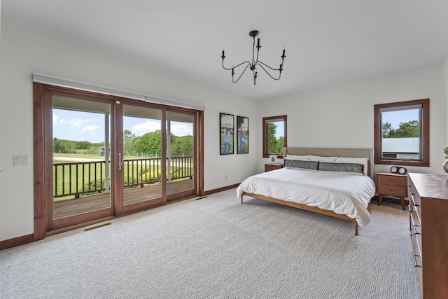 4230 Dalby Rd, Black Earth, WI 53515 - bedroom with a chandelier, multiple windows, access to outside, and baseboards