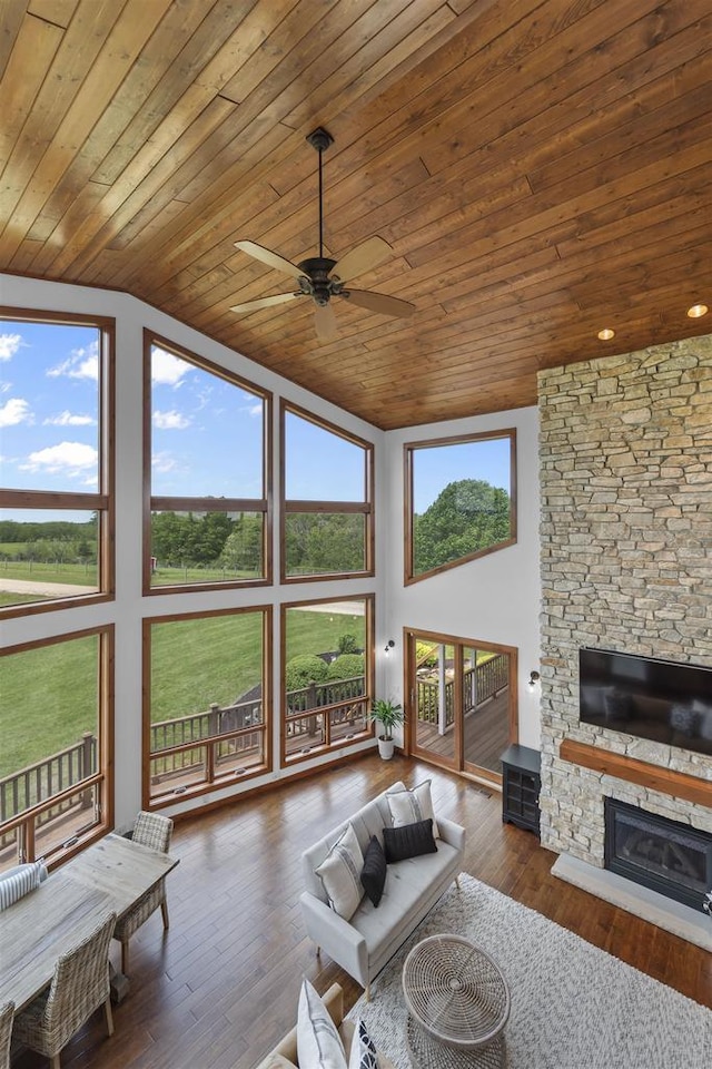 4230 Dalby Rd, Black Earth, WI 53515 - living area with ceiling fan, wood ceiling, a stone fireplace, hardwood / wood-style floors, and high vaulted ceiling