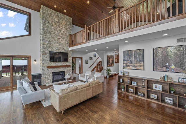 4230 Dalby Rd, Black Earth, WI 53515 - living area with high vaulted ceiling, a stone fireplace, a ceiling fan, wood ceiling, and stairs