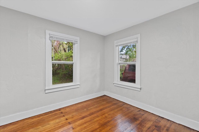 5015 N 25th St, Milwaukee, WI 53209 - unfurnished room featuring plenty of natural light, baseboards, and hardwood / wood-style flooring