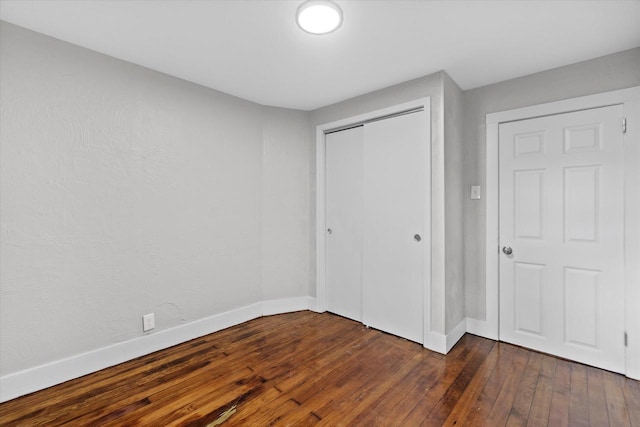 5015 N 25th St, Milwaukee, WI 53209 - unfurnished bedroom with dark wood finished floors, baseboards, and a closet