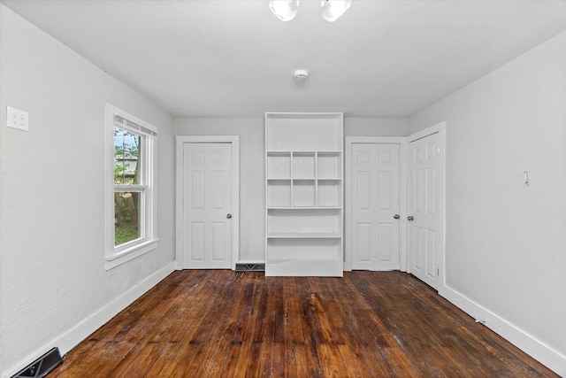 5015 N 25th St, Milwaukee, WI 53209 - unfurnished bedroom featuring dark wood-style flooring and baseboards