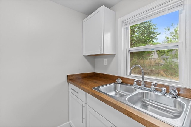 5015 N 25th St, Milwaukee, WI 53209 - kitchen featuring a sink, white cabinets, and butcher block countertops