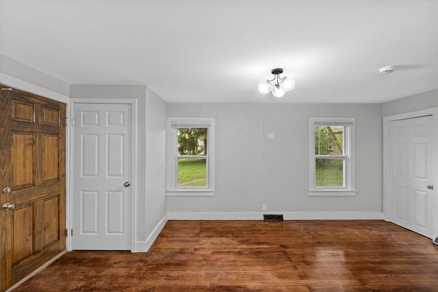 5015 N 25th St, Milwaukee, WI 53209 - unfurnished bedroom with wood finished floors, baseboards, and a chandelier