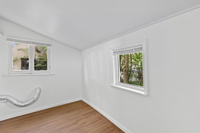 5015 N 25th St, Milwaukee, WI 53209 - empty room with lofted ceiling, healthy amount of natural light, baseboards, and wood finished floors