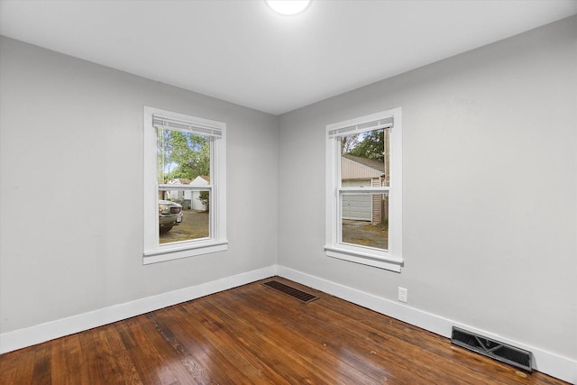5015 N 25th St, Milwaukee, WI 53209 - unfurnished room featuring baseboards, plenty of natural light, and dark wood finished floors