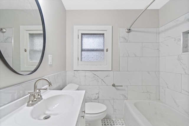 5015 N 25th St, Milwaukee, WI 53209 - full bath with toilet, vanity, tile walls, tub / shower combination, and a wainscoted wall