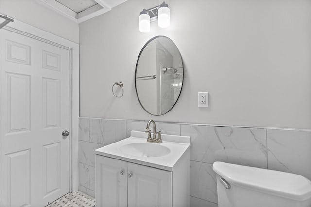 5015 N 25th St, Milwaukee, WI 53209 - bathroom with a wainscoted wall, tile walls, toilet, and vanity