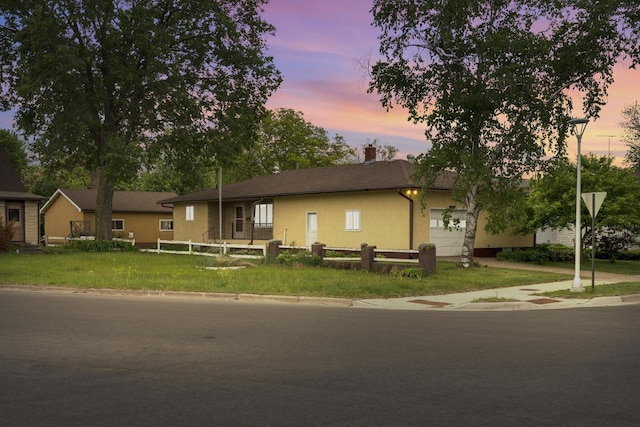 2530 Onalaska Ave, La Crosse, WI 54603 - ranch-style house featuring a garage, stucco siding, and a chimney