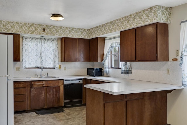 2530 Onalaska Ave, La Crosse, WI 54603 - kitchen with dishwashing machine, a sink, light countertops, and black microwave