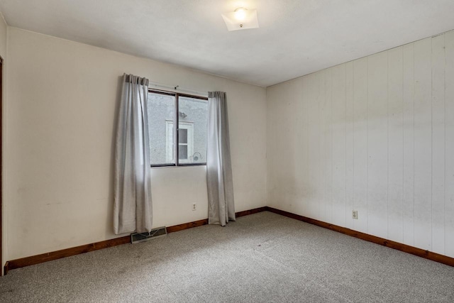2530 Onalaska Ave, La Crosse, WI 54603 - carpeted spare room with baseboards and wooden walls