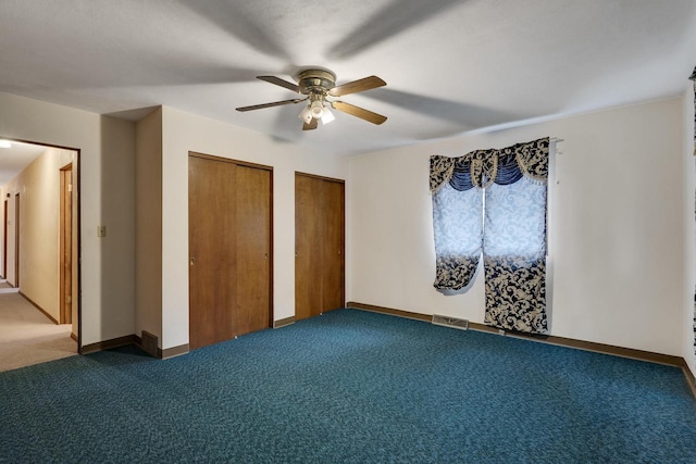2530 Onalaska Ave, La Crosse, WI 54603 - unfurnished bedroom featuring carpet floors, multiple closets, ceiling fan, and baseboards