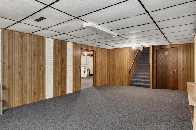 2530 Onalaska Ave, La Crosse, WI 54603 - finished below grade area with a drop ceiling, wooden walls, stairs, carpet flooring, and washer / clothes dryer