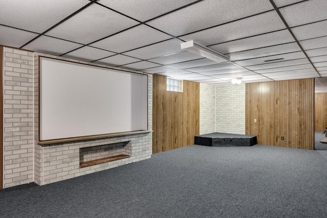 2530 Onalaska Ave, La Crosse, WI 54603 - home theater room featuring carpet flooring, a paneled ceiling, and wood walls