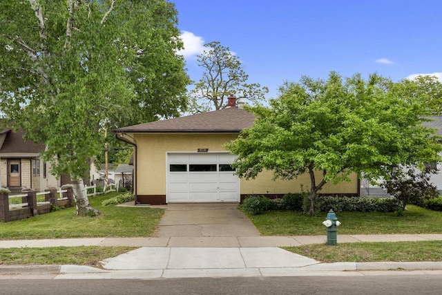 2530 Onalaska Ave, La Crosse, WI 54603 - view of property hidden behind natural elements featuring driveway, stucco siding, an attached garage, a front lawn, and roof with shingles