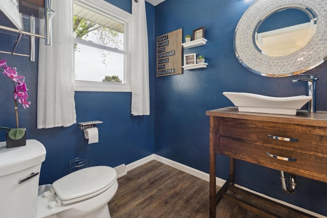1089 Audrey Ct, North Fond Du Lac, WI 54937 - half bathroom featuring toilet, wood finished floors, baseboards, and vanity