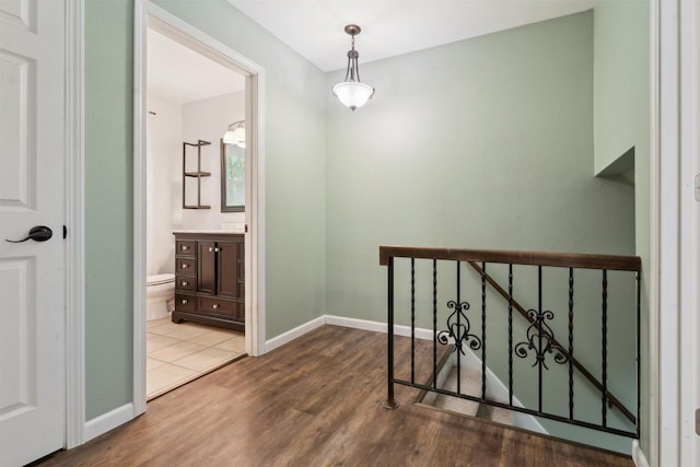 1089 Audrey Ct, North Fond Du Lac, WI 54937 - hall featuring wood finished floors, an upstairs landing, and baseboards