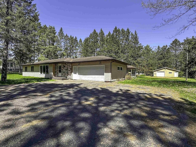 1200 4th Ave N, Park Falls, WI 54552 - view of front of house featuring an attached garage, asphalt driveway, and a front yard